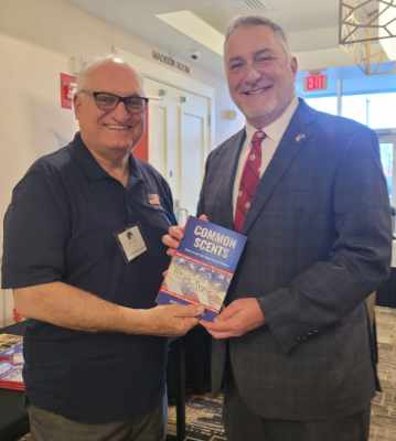 Phil presenting his book to John Reid who was running for Lt. Govener of Virginia in 2025.