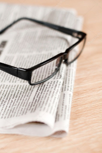 depositphotos_9187256-stock-photo-eyeglasses-lying-around-newspapers_cropped